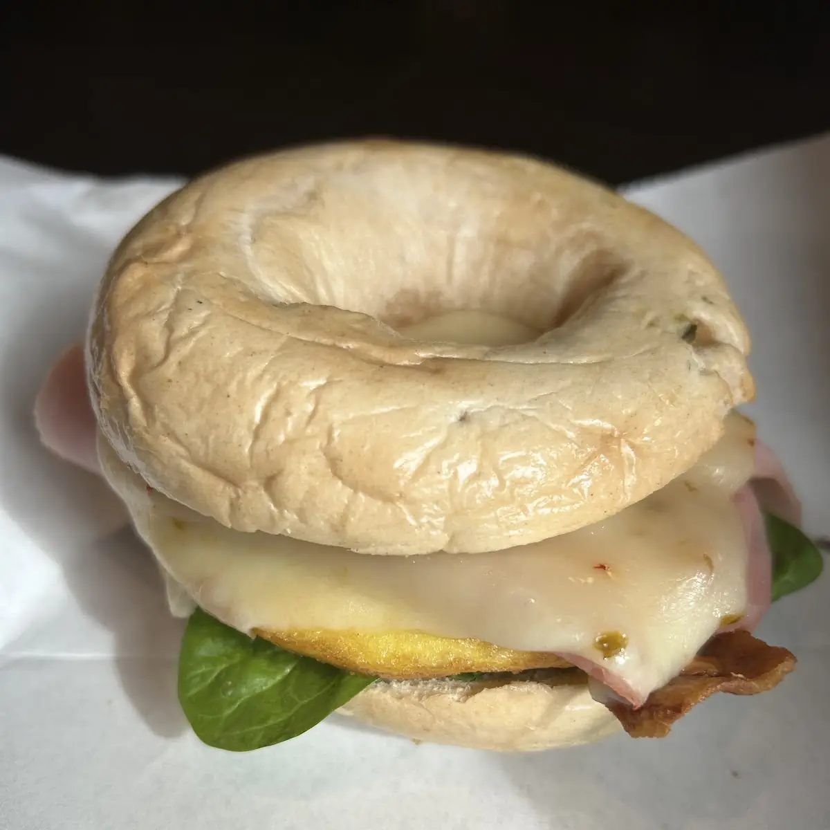 Onion Bagel with Bacon Egg Arugula