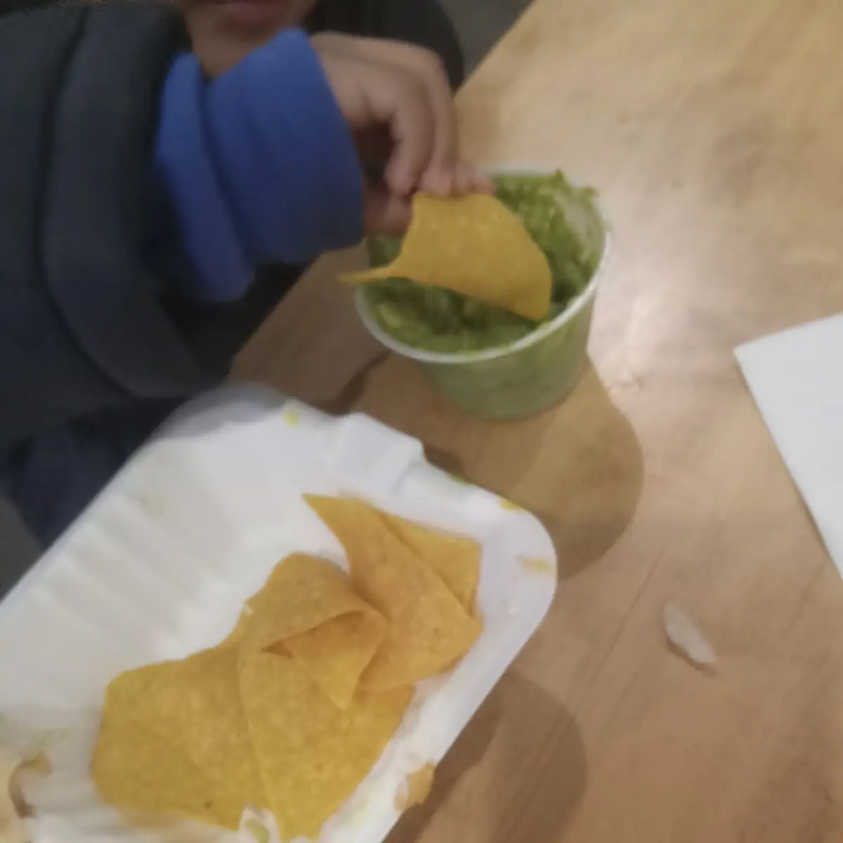 Tiny Fingers Enjoying Fresh Guacamole and Chips
