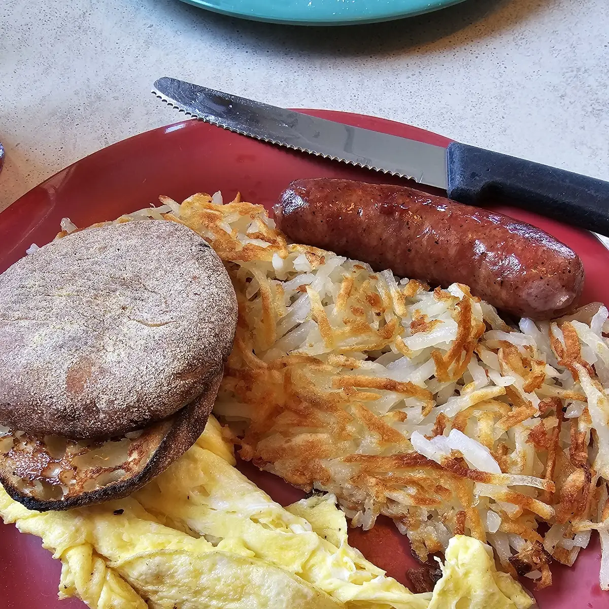 Scrambled Eggs Sausage Link Hash Browns and English Muffin