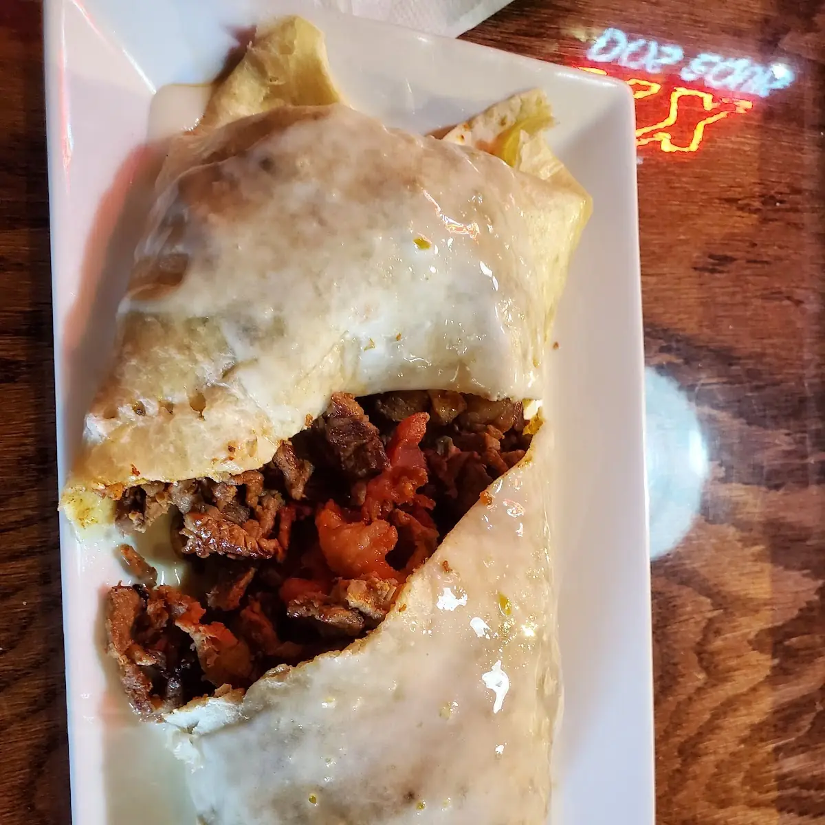 Steak Burrito with Added Bacon with Queso on Top