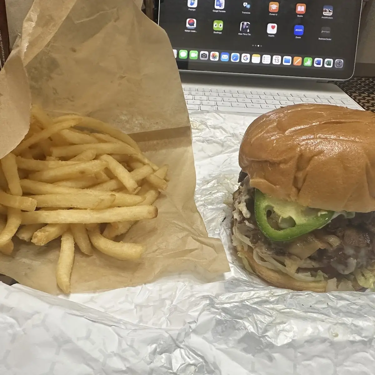 Double Cheese Burger with Everything on It Including Jalapeños and Avocado