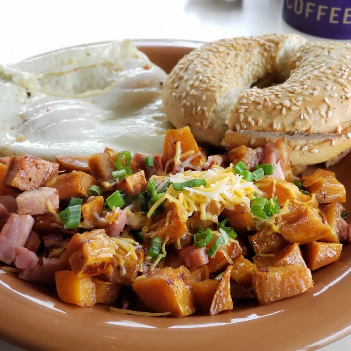 Sesame Bagel and Cream Cheese and Eggs over Easy