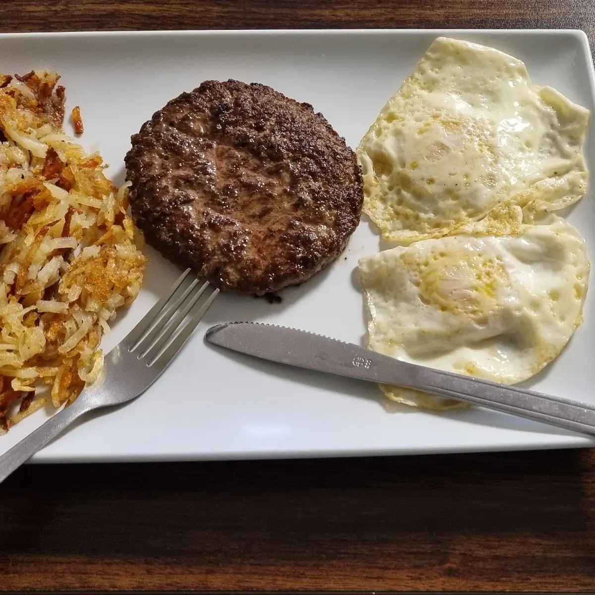 2 Eggs Hamburger Steak Hash Browns and Sliced Tomatoe