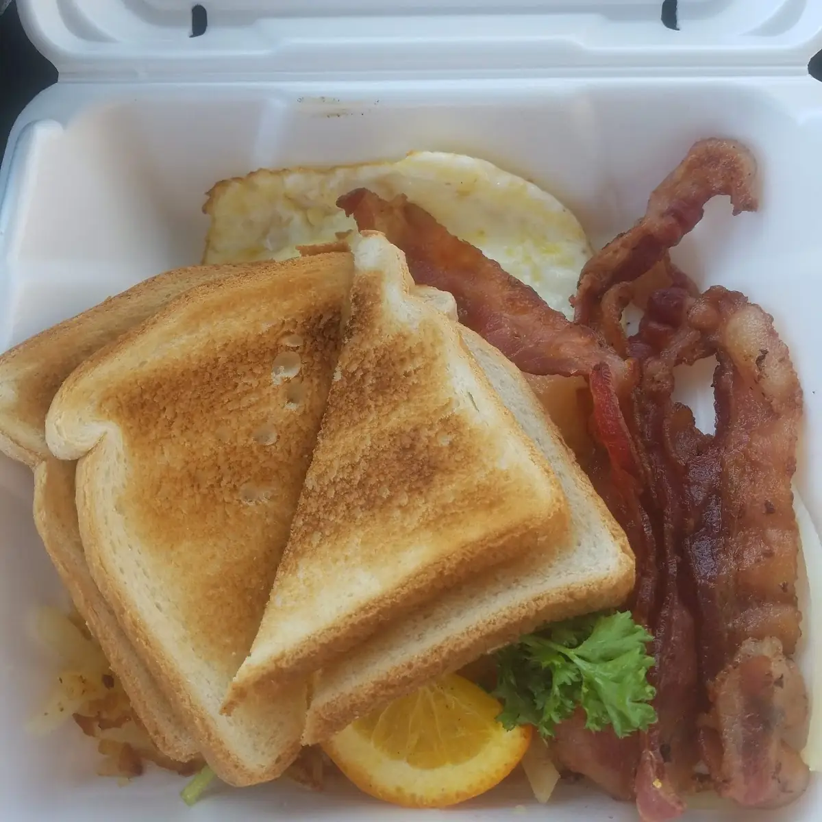Eggs over Medium with Hash Browns Bacon and White Toast