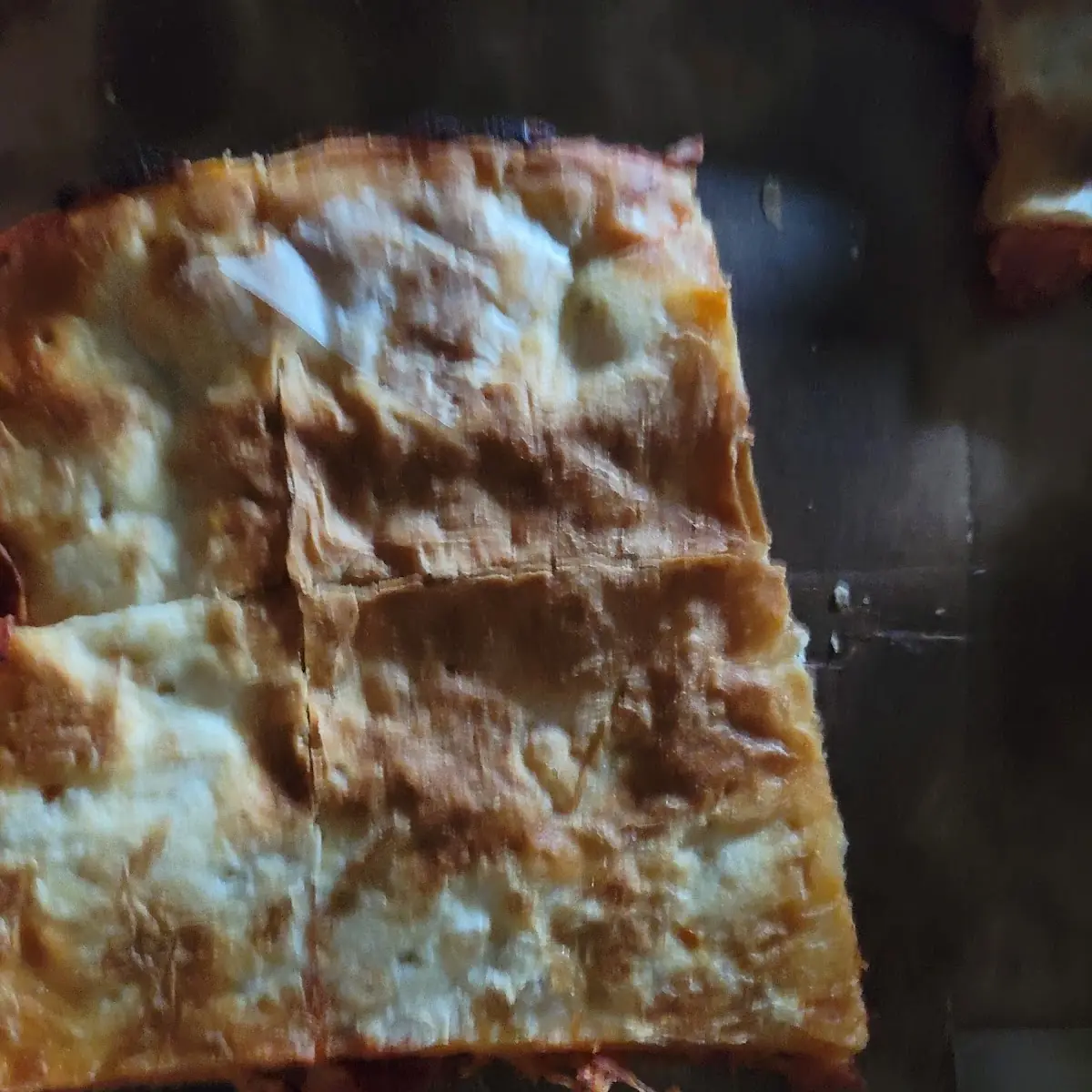 Thin Crust Pepperoni Pizza with Paper Stuck on Bottom