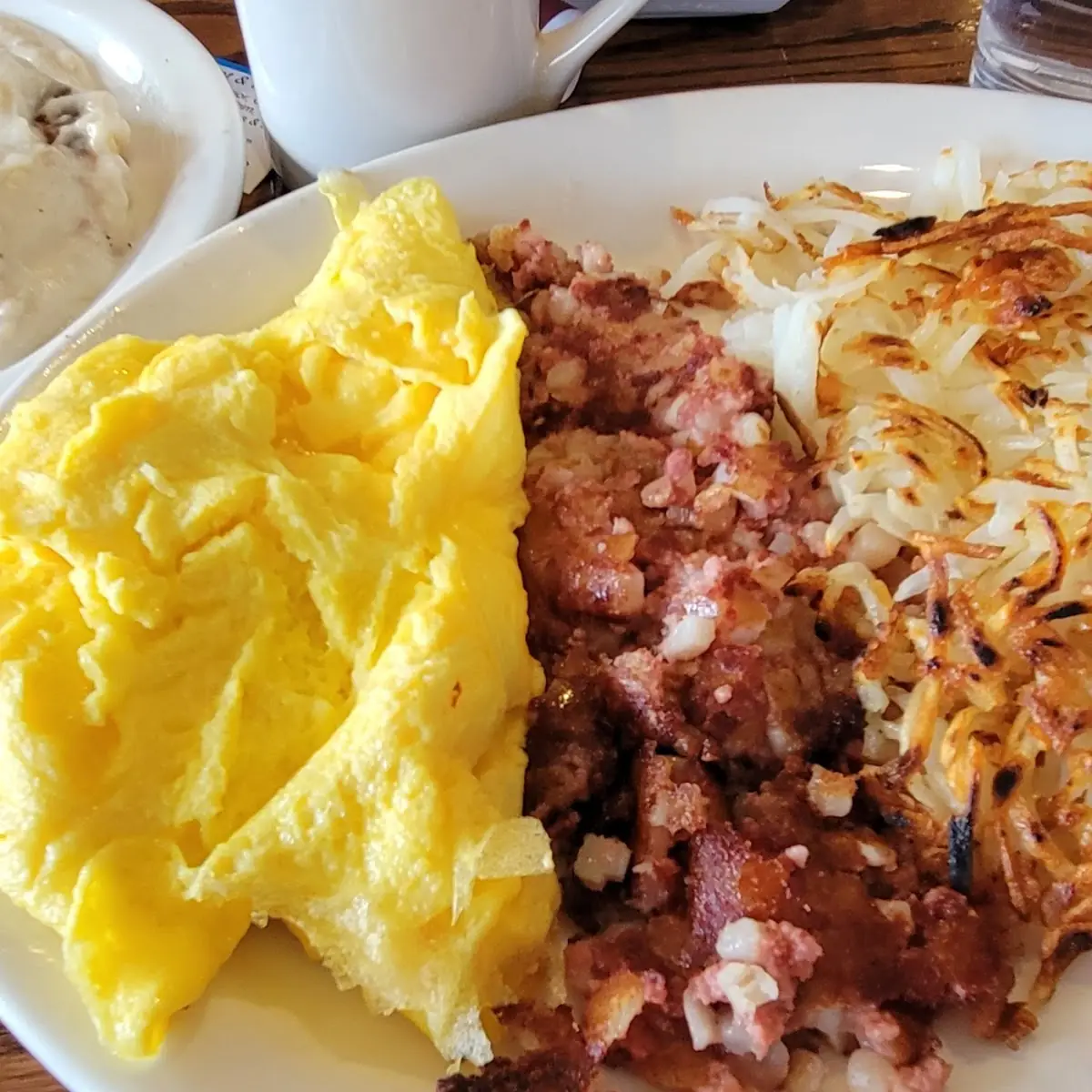 Scrambled Eggs with Corned Beef Hash and Hash Browns Biscuits and Gravy