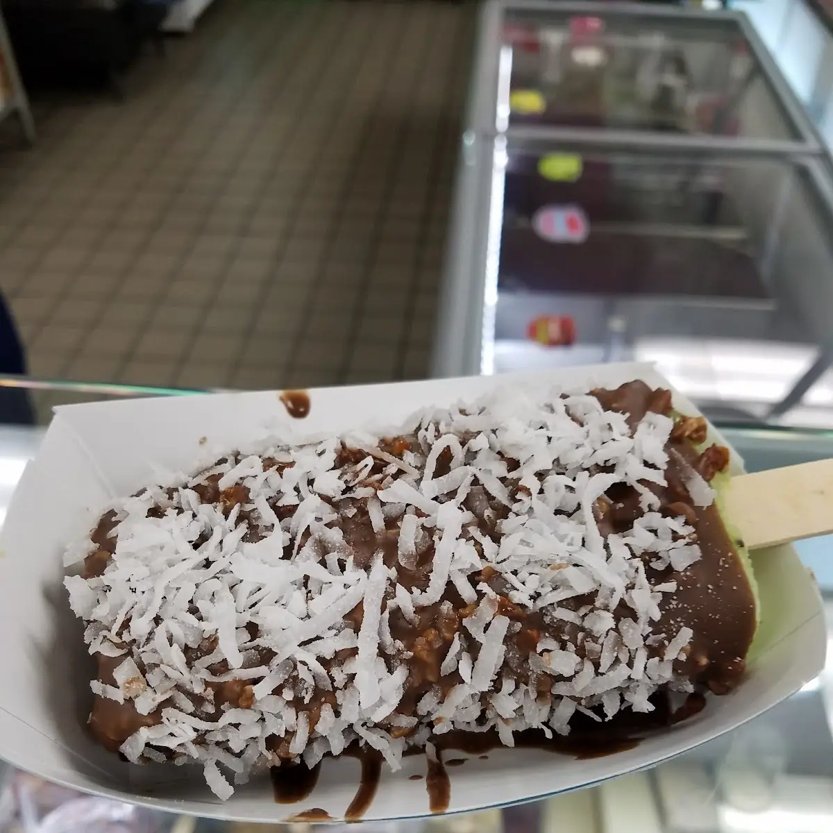 Coconut Popsicle Dipped into Chocolate Covered by Shaved Coconut