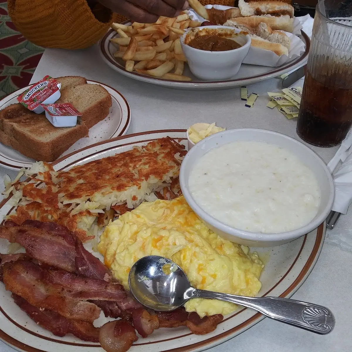 Eggs Bacon Hash Browns Grits and Wheat Toast