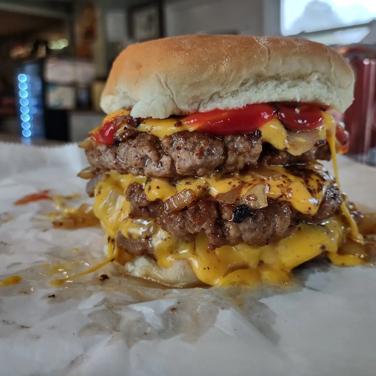 Triple Cheeseburger with Extra Cheese and Grilled Onions