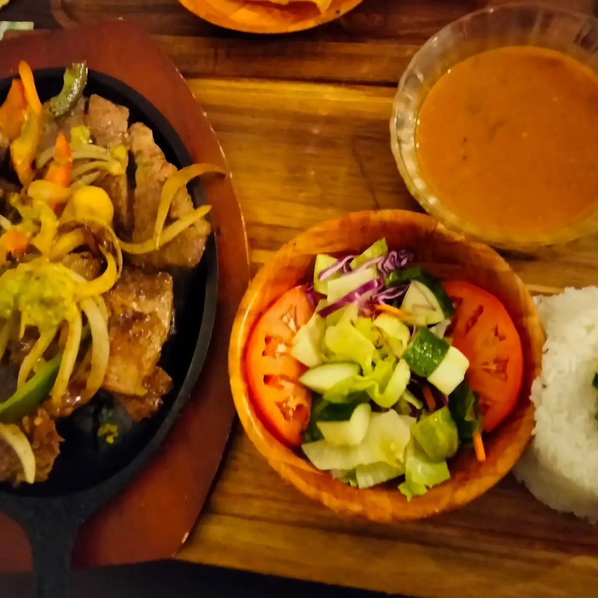Steak with Peppers Rice and Beans with a Side Salad