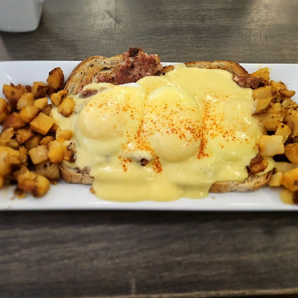 Eggs Benedict with Hash and Sausage