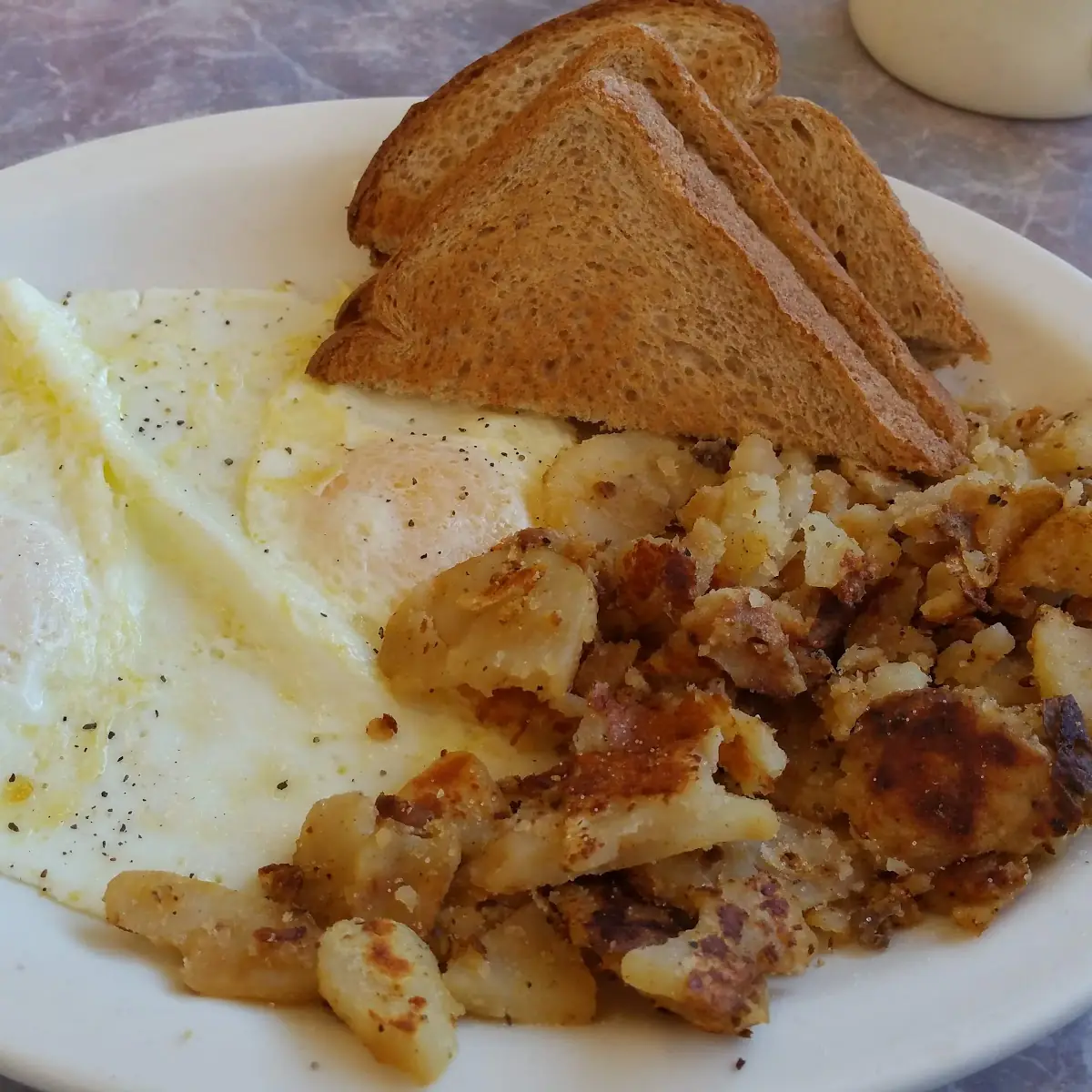 Fried Eggs Whole Wheat Toast and Hash Browns