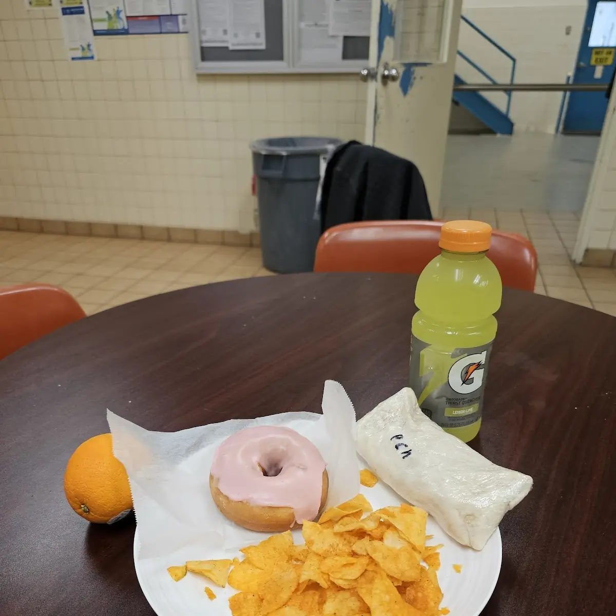 Strawberry Doughnut and Burrito and a Orange Juice