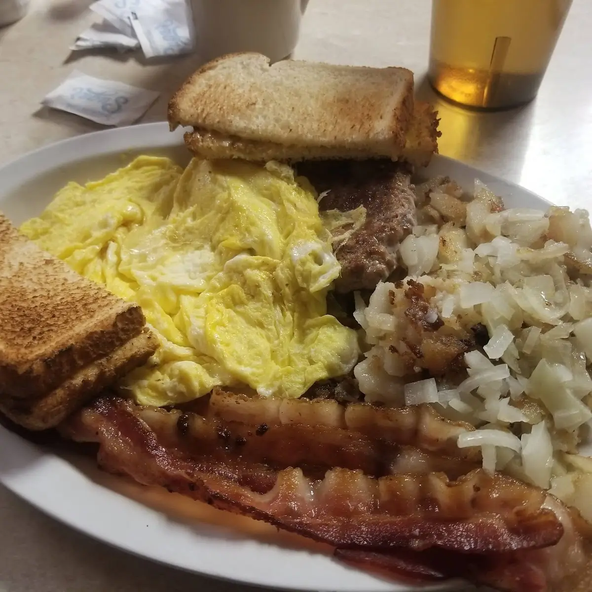 2 Eggs Hash Brown Potatoes Three Meat and Toast