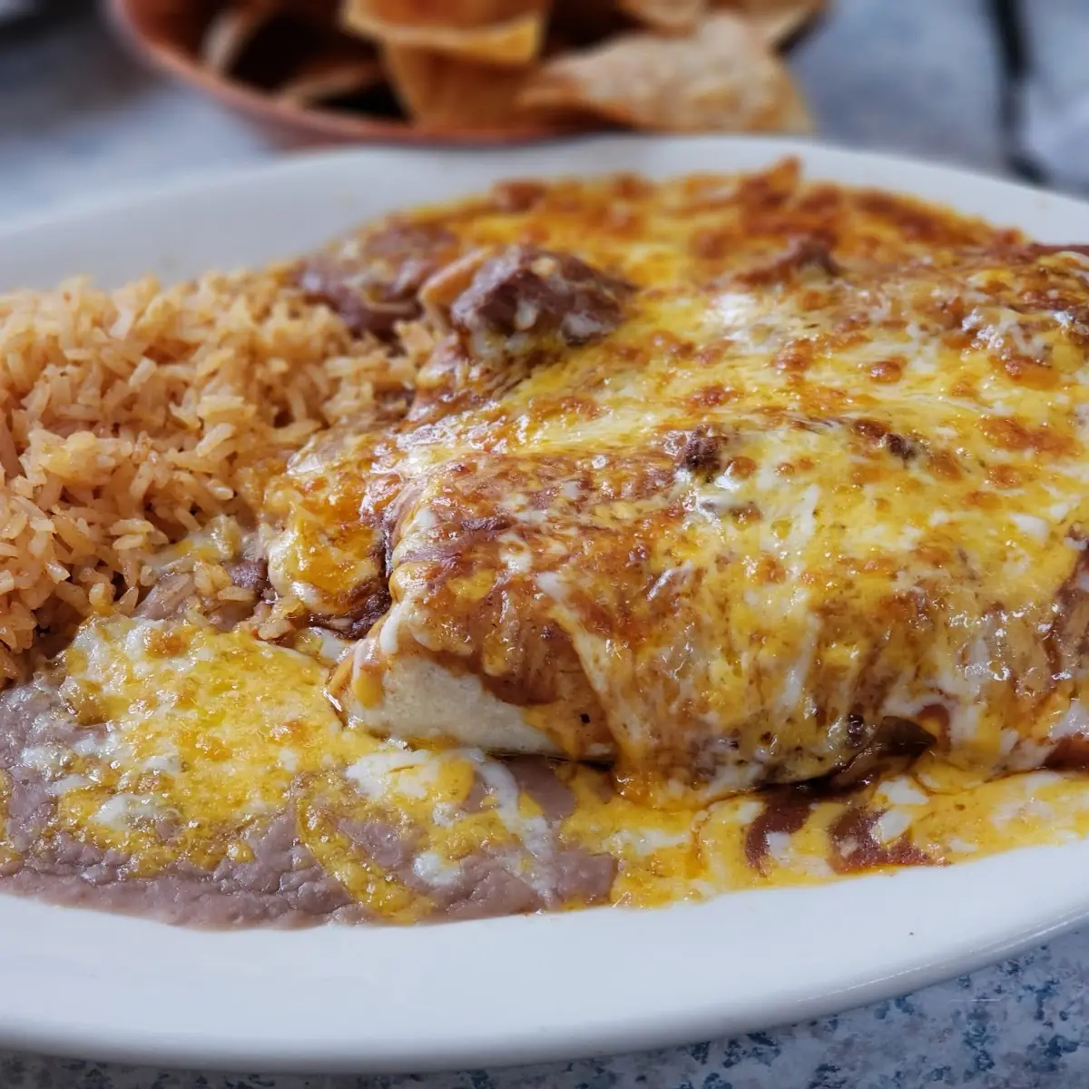 Shredded Beef Burrito Shredded Beef Enchilada and Ground Beef Tostada with Beans and Rice