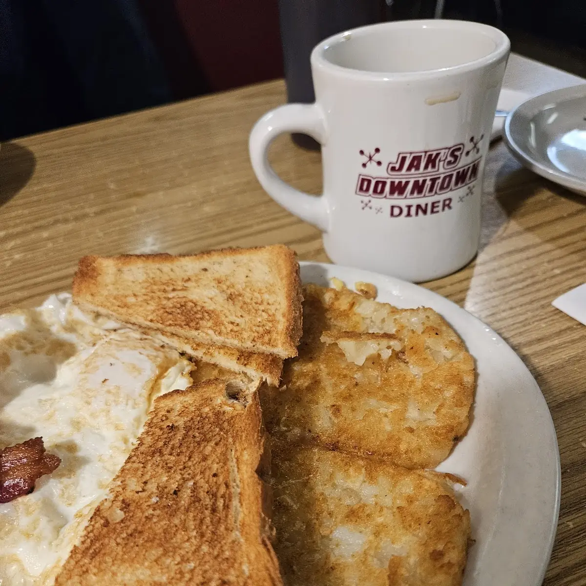 2 Eggs OE w 1 2 Bacon White Toast Hash Browns