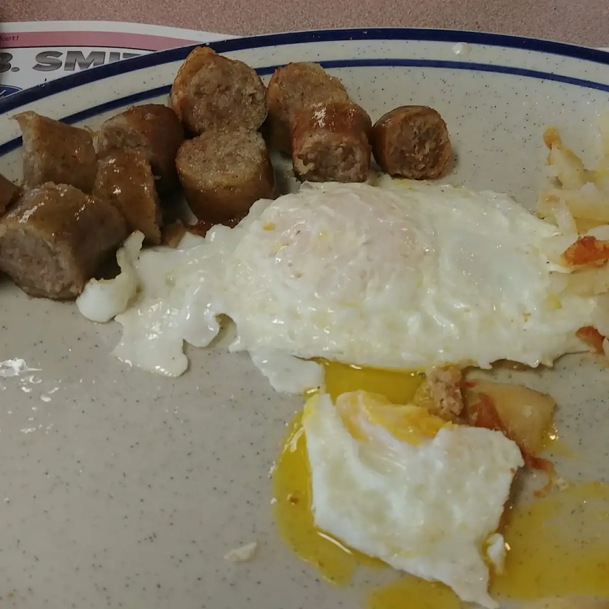 Sausage Eggs over Easy Shredded Hash Browns and Wheat Tea