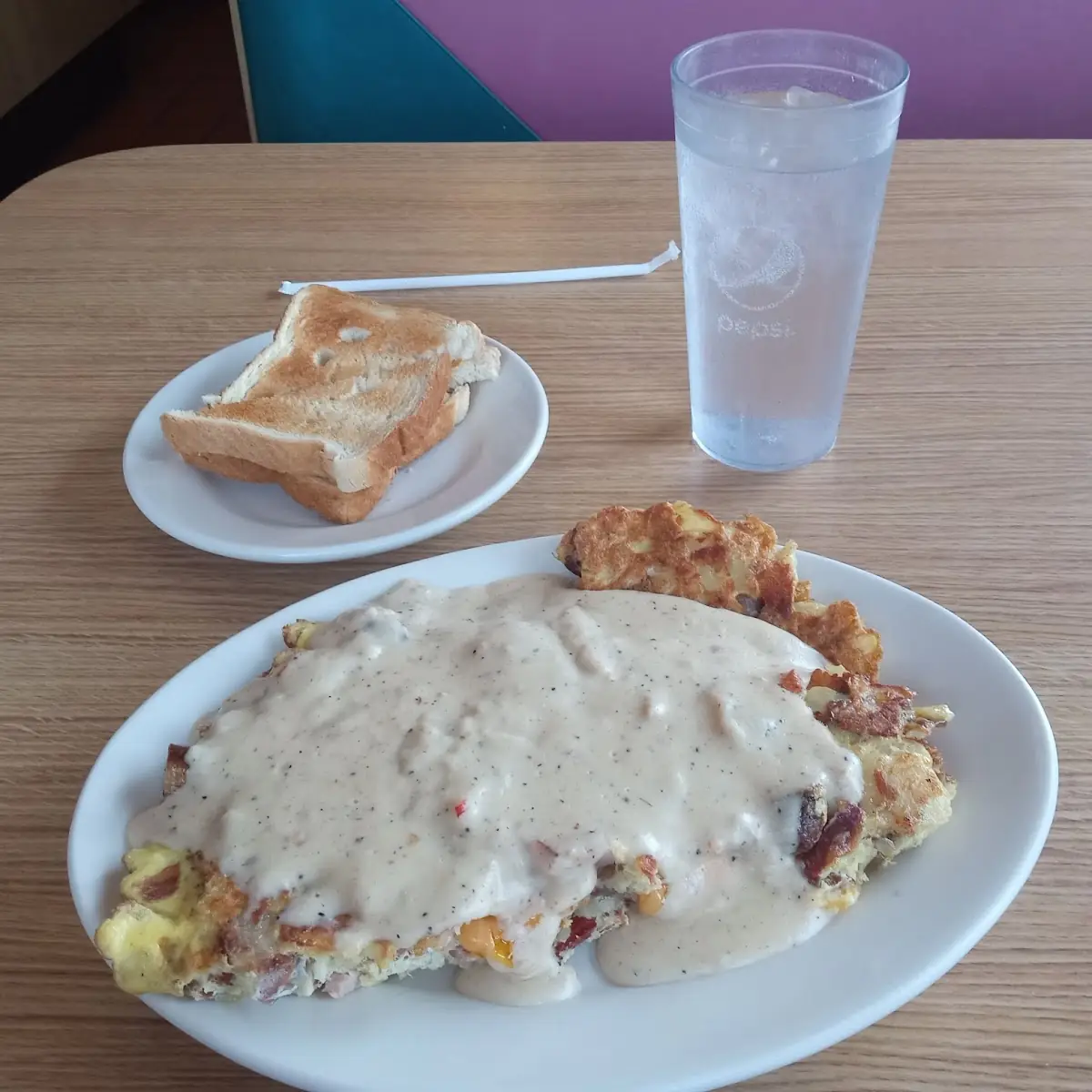 Ham Cheese Hasbrowns Sausage and Bacon Omelette Covered in Sausage Gravy
