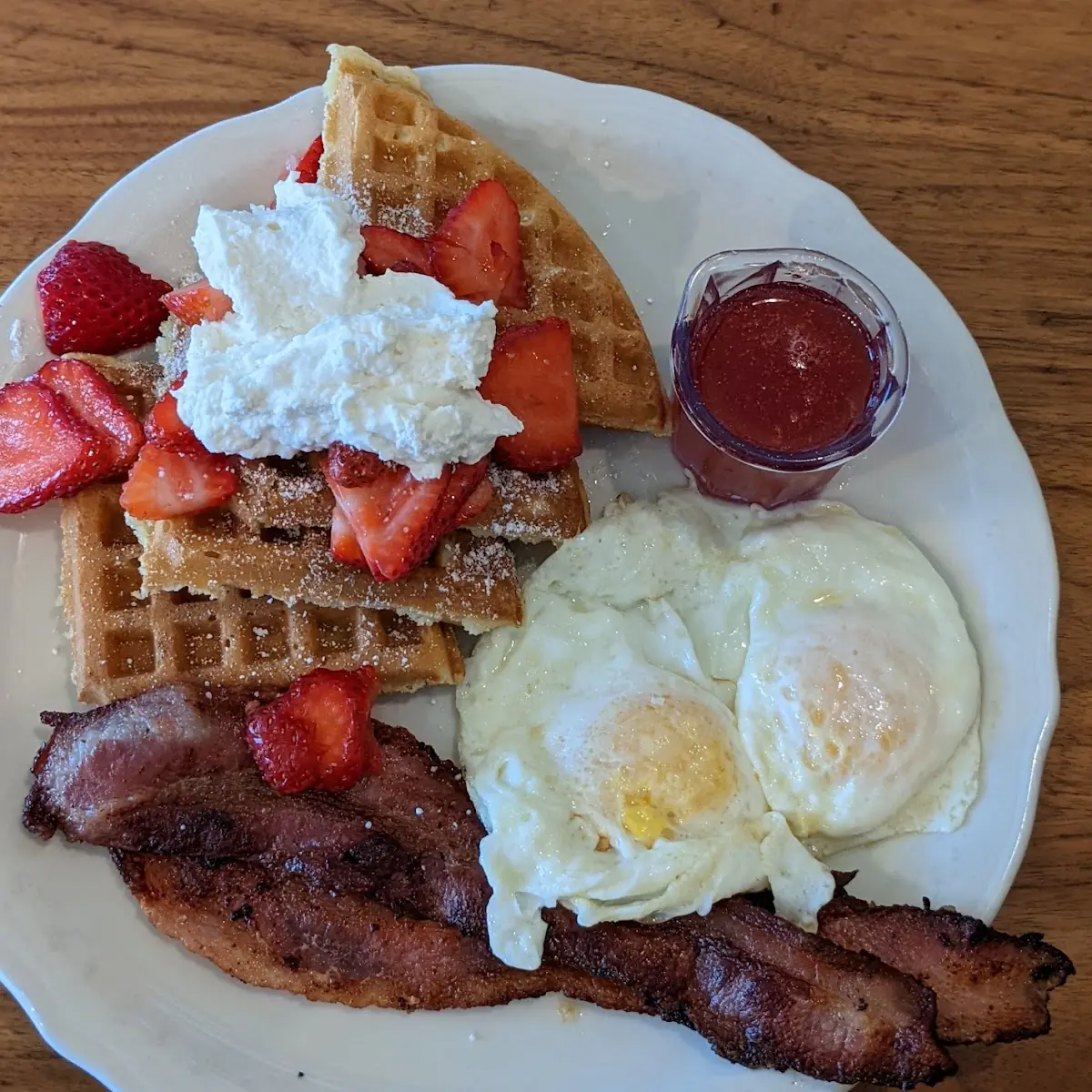 Strawberry Waffles w Eggs over Medium and Bacon
