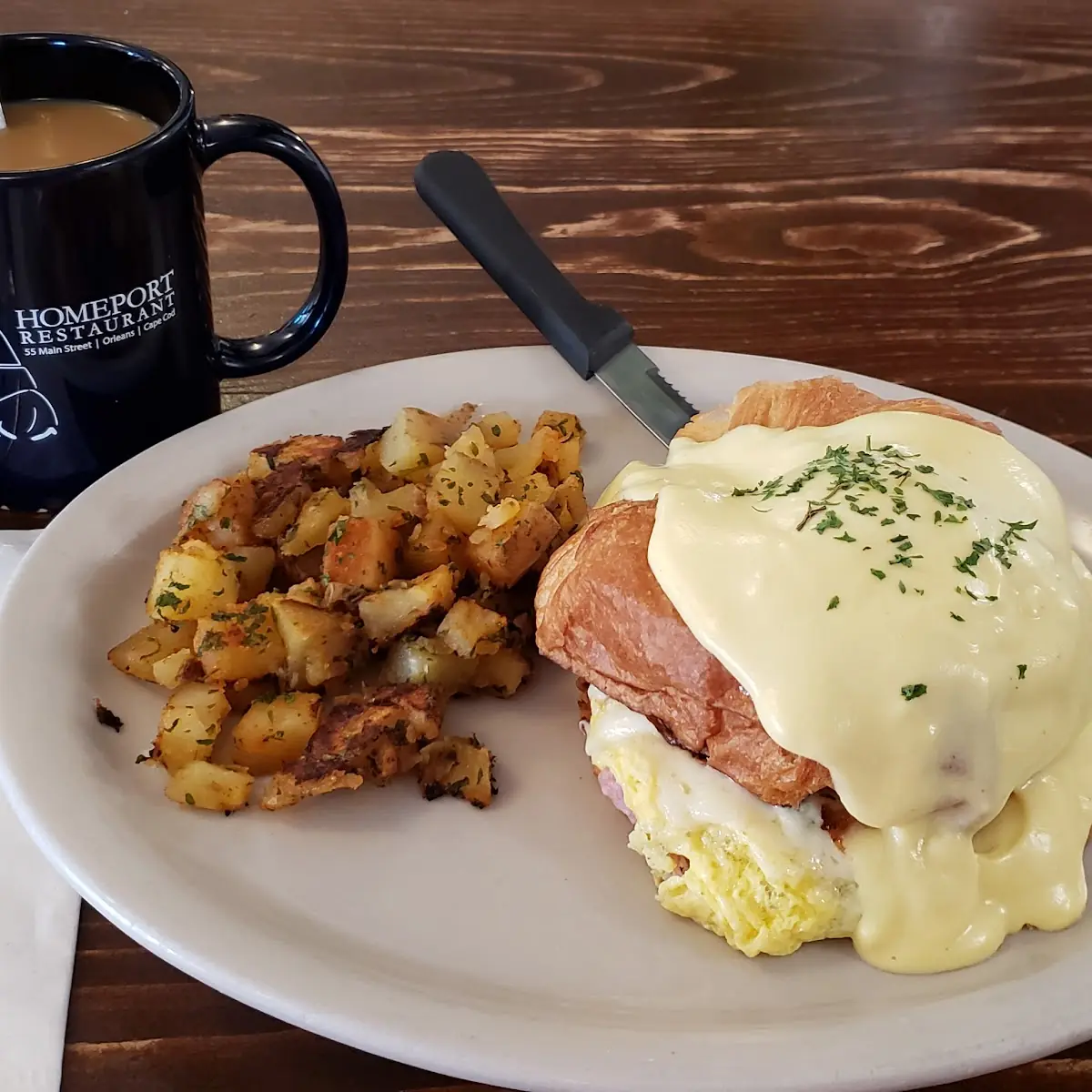 Stuffed Croissant with Scrambled Eggs Ham Cheese and Broccoli with Hollandaise Sauce