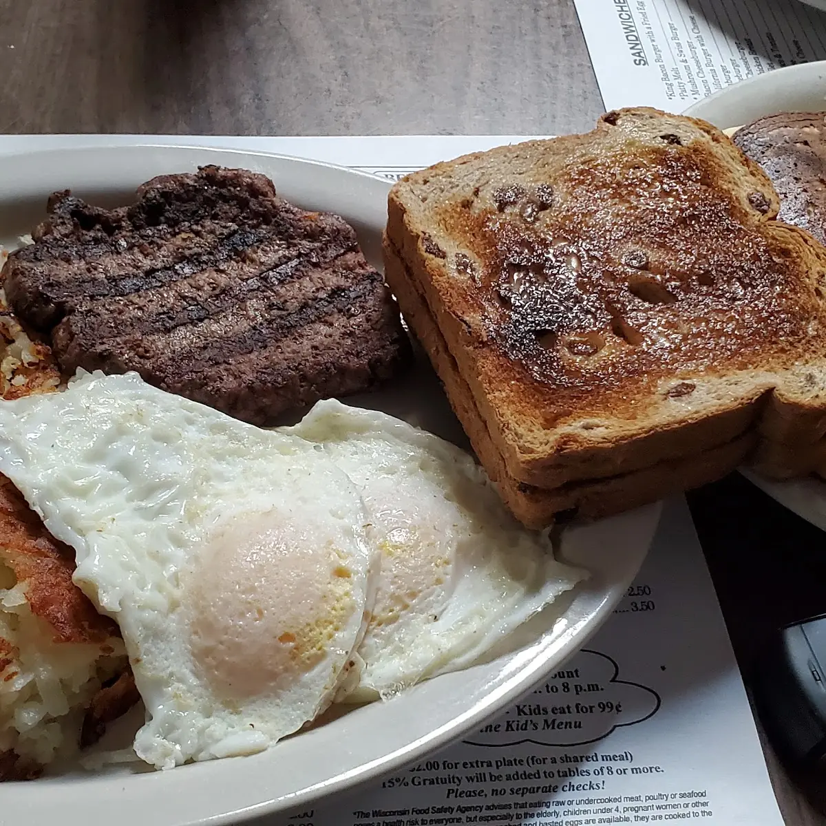 Hamburger Patty Eggs Hashbrowns Raisin Bread Blueberry Pancakes