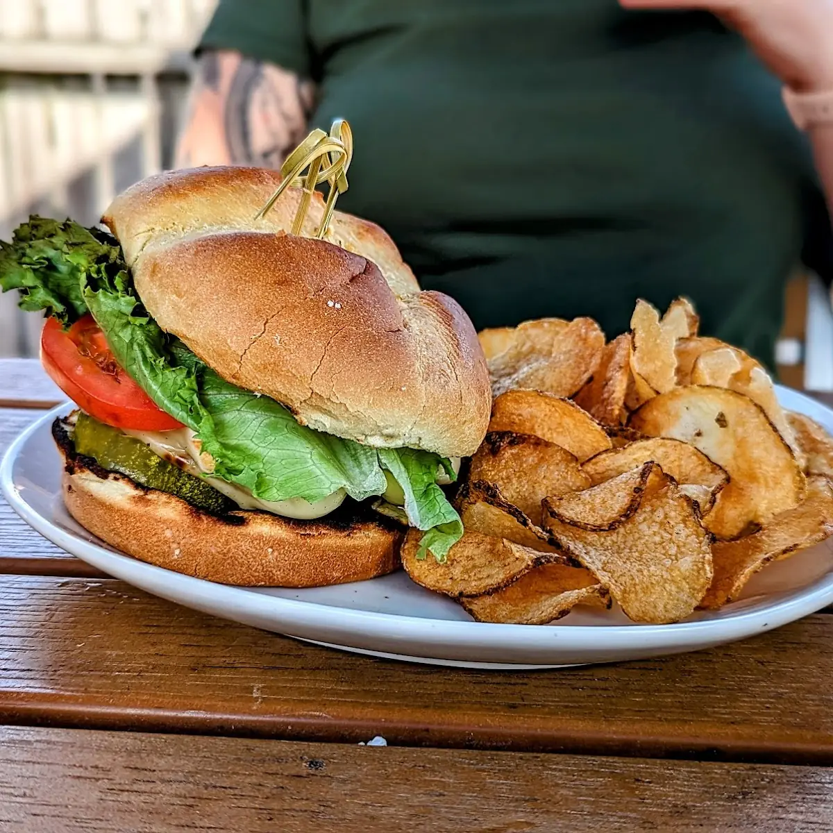 With Pickles & House Kettle Chips on a Brioche Bun