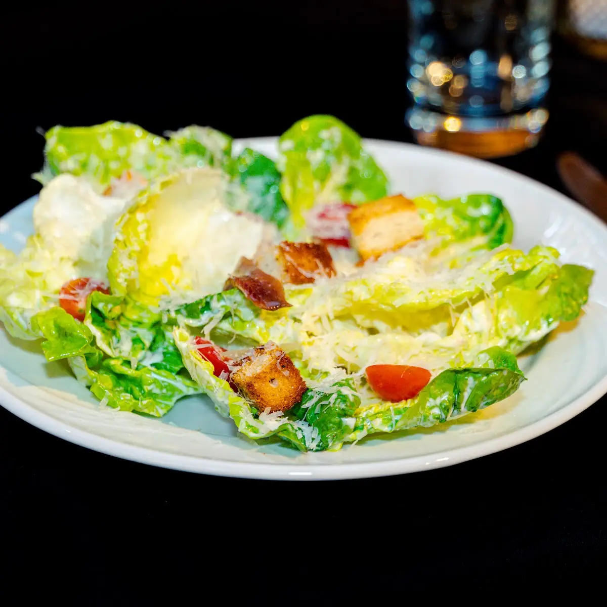 Caesar Salad with House-Made Caesar Dressing Croutons Cherry Tomatoes and Parmesan