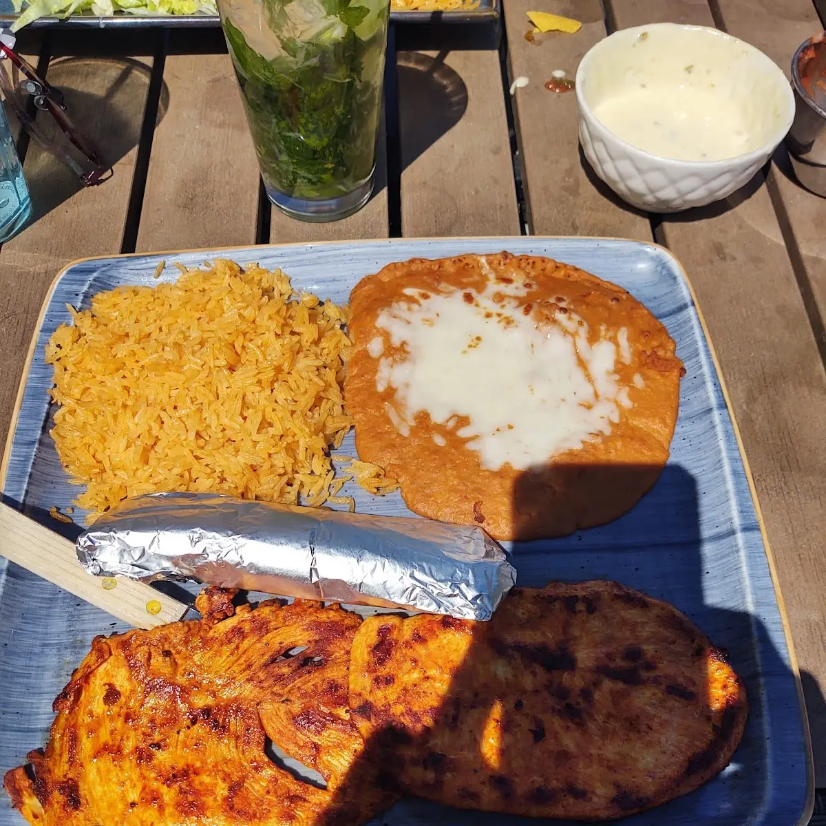 One Quesadilla Filled with Sauteed Onions and Your Choice of Grilled Steak or Chicken. Served with a Side of Crema Salad and Your Choice of Rice Beans