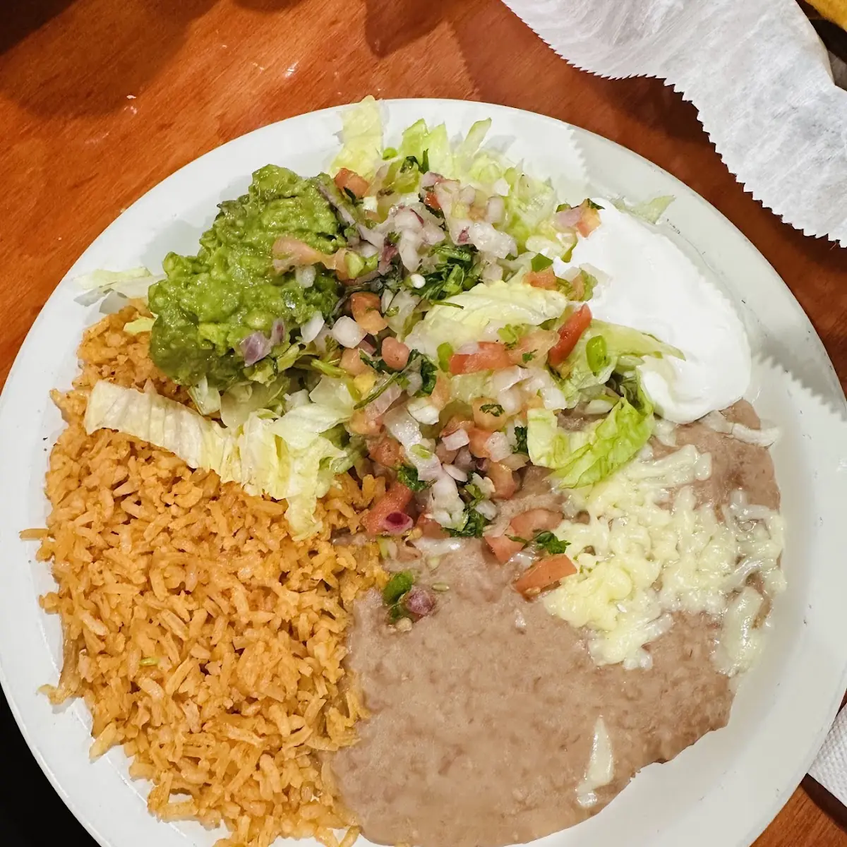 One Guacamole Tostada One Beef Enchilada Rice and Beans