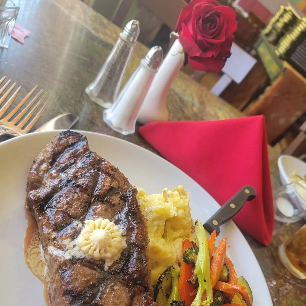 New York Steak with Smashed Potatoes Gorgonzola Compound Butter and Grilled Veggies