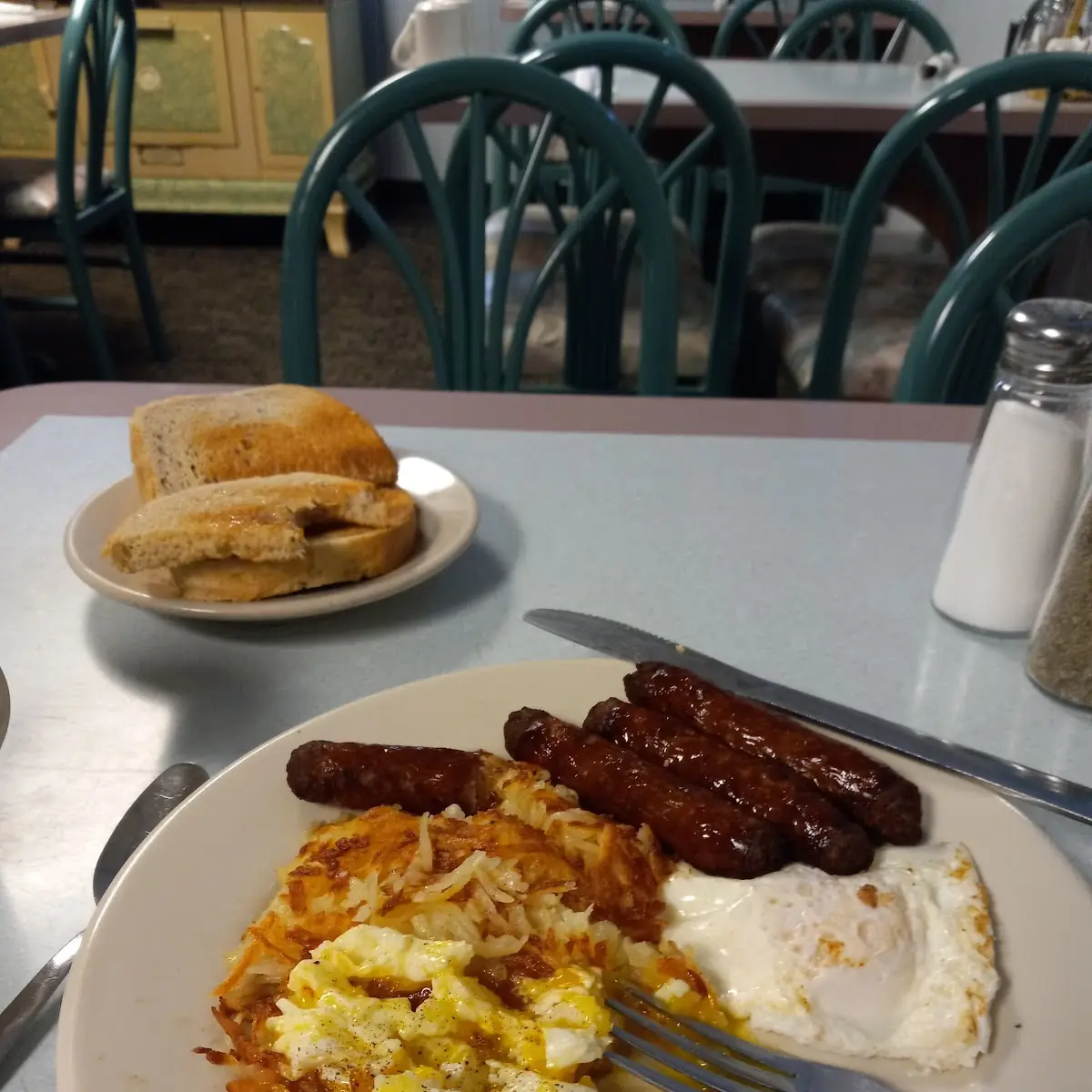Two Eggs over Easy Extra Crispy Tatoes Sausage Links and Rye Toast