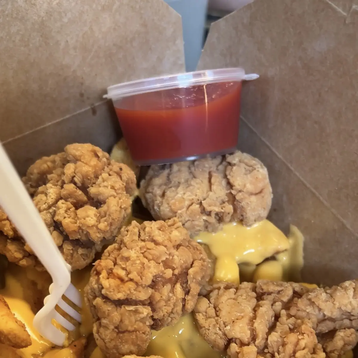 Popcorn Chicken & Fries with Cheese Sauce
