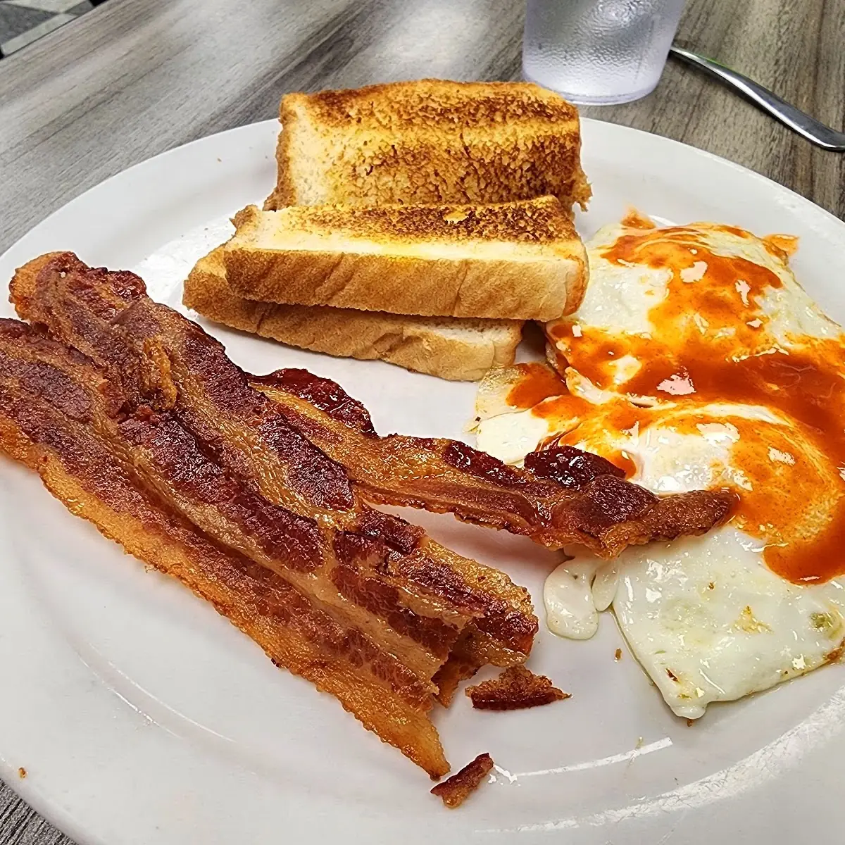 Bacon and Eggs over Medium with Hot Sauce