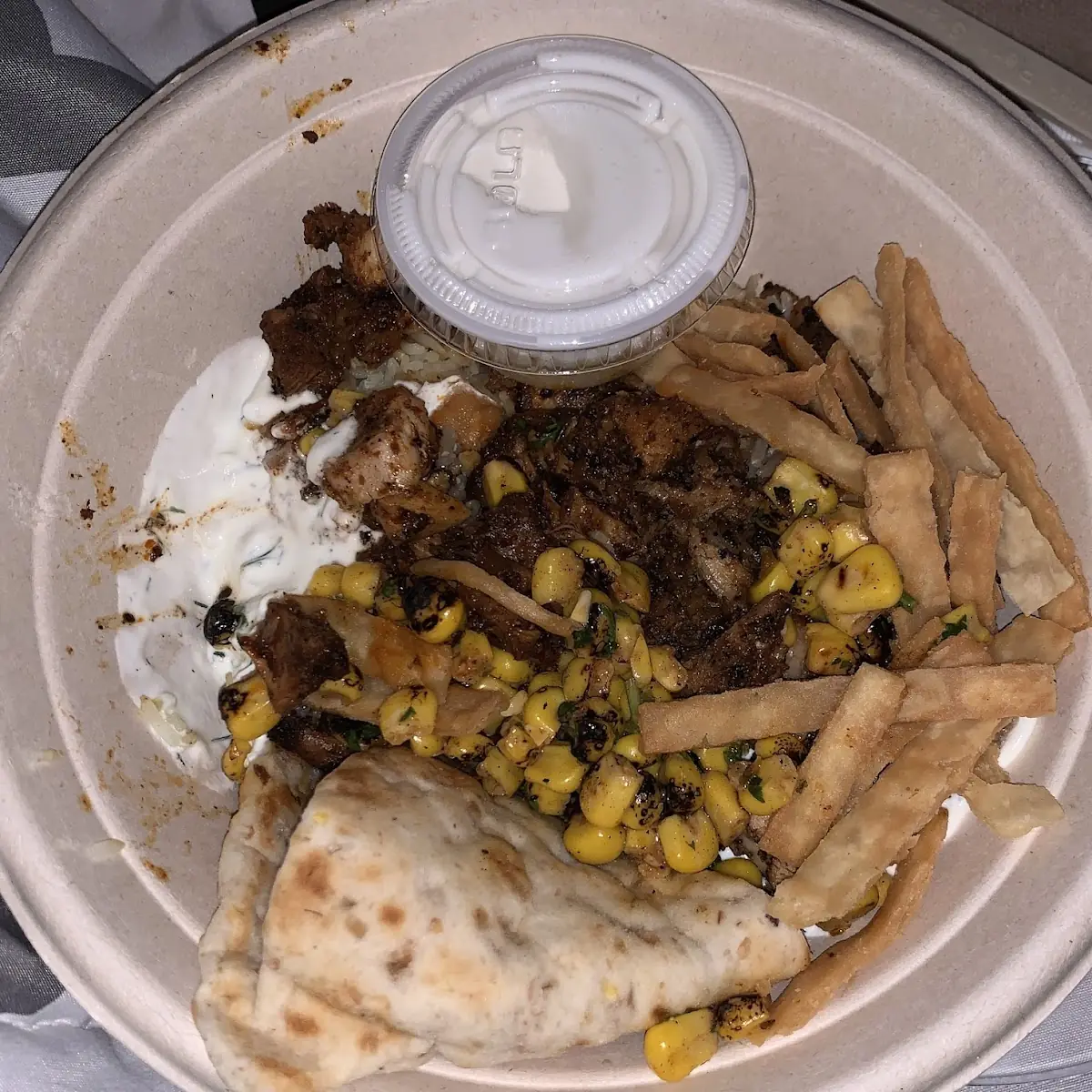 Grains Bowl Half Saffron Rice Half Harhon Chicken Bowl Fire Roasted Corn Pita Crisp