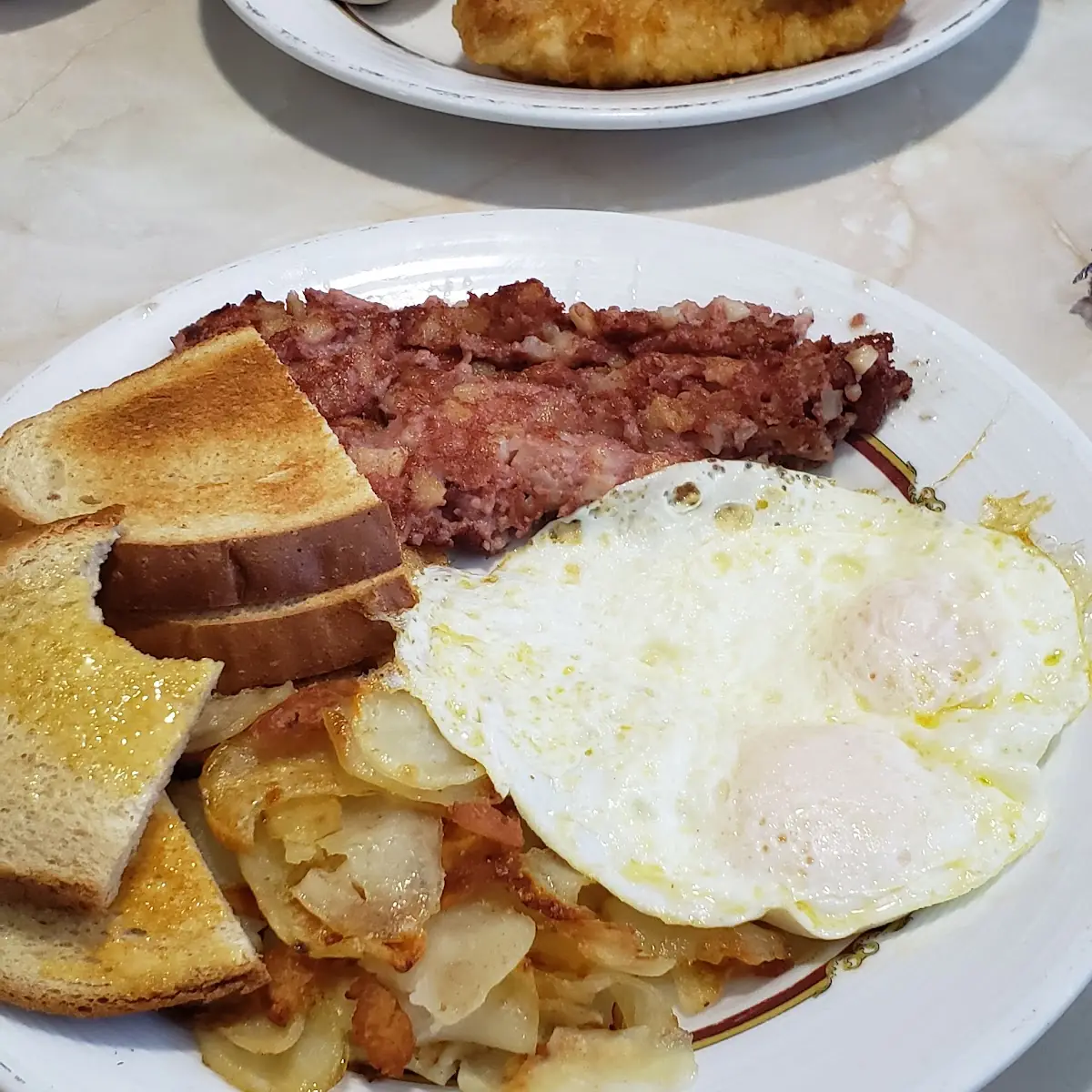 Eggs over Easy Corn Beef Hash American Potatoes and Rye Toast