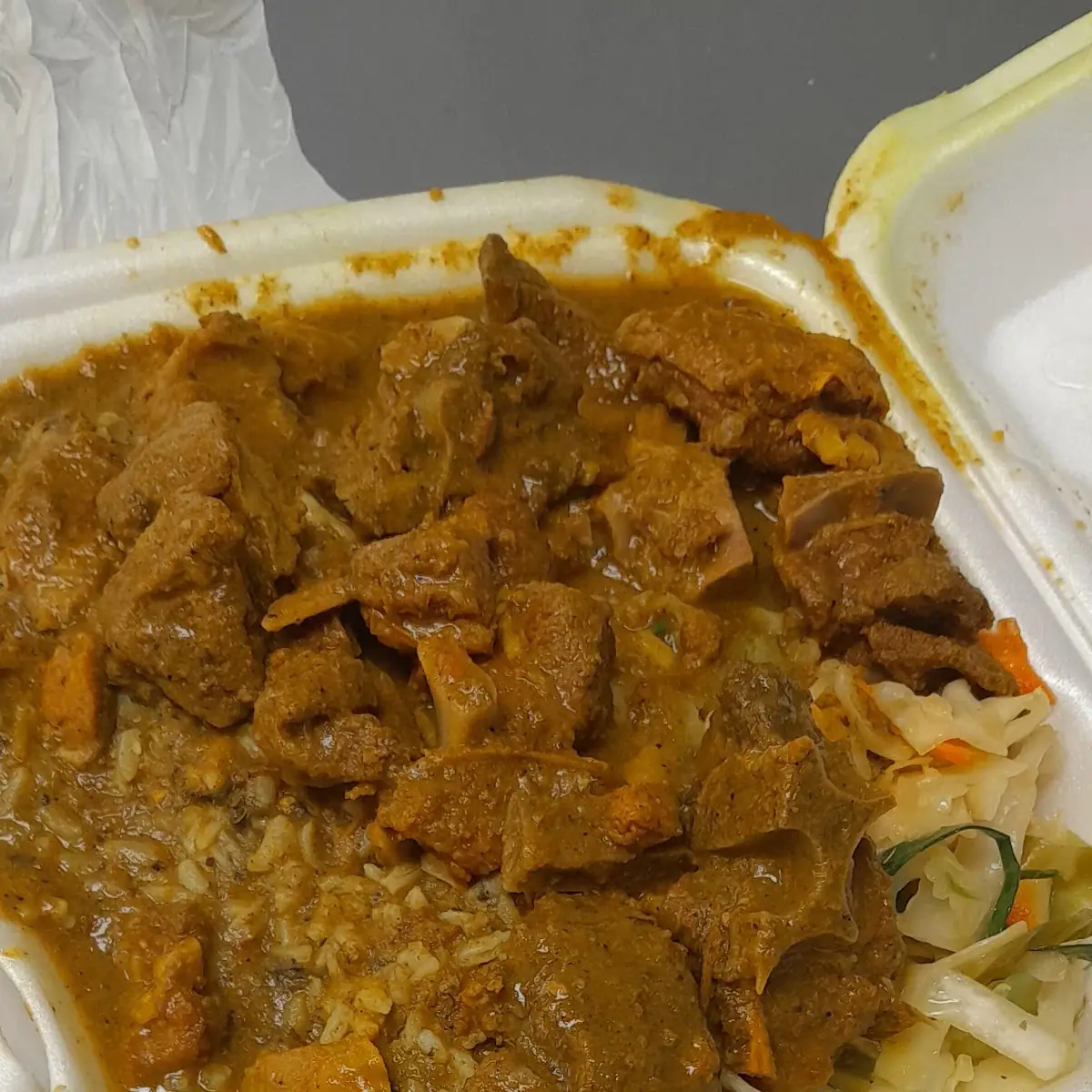 Curry Goat Spinach Rice and Cabbage