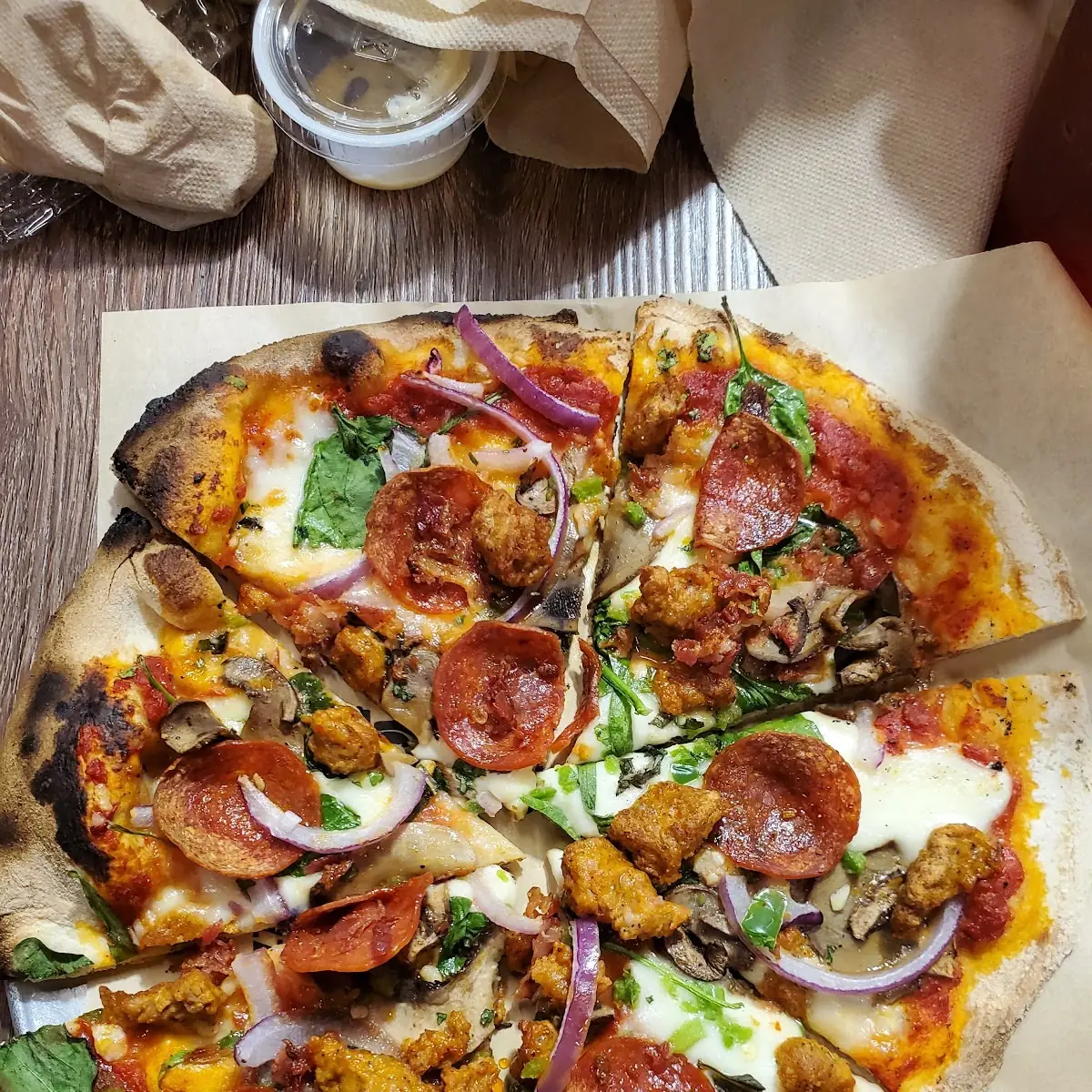 Spicy Italian Sausage Pepperoni Spinach Basil Jalapeños Red Onions