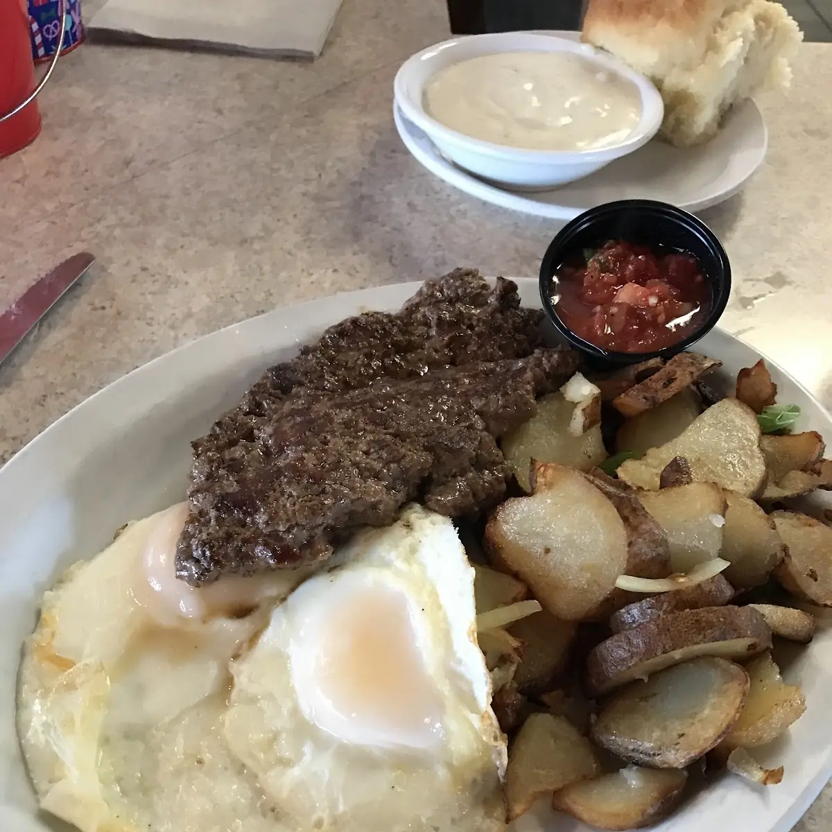 Hamburger Patty Eggs Hash Browns and Biscuits Gravy