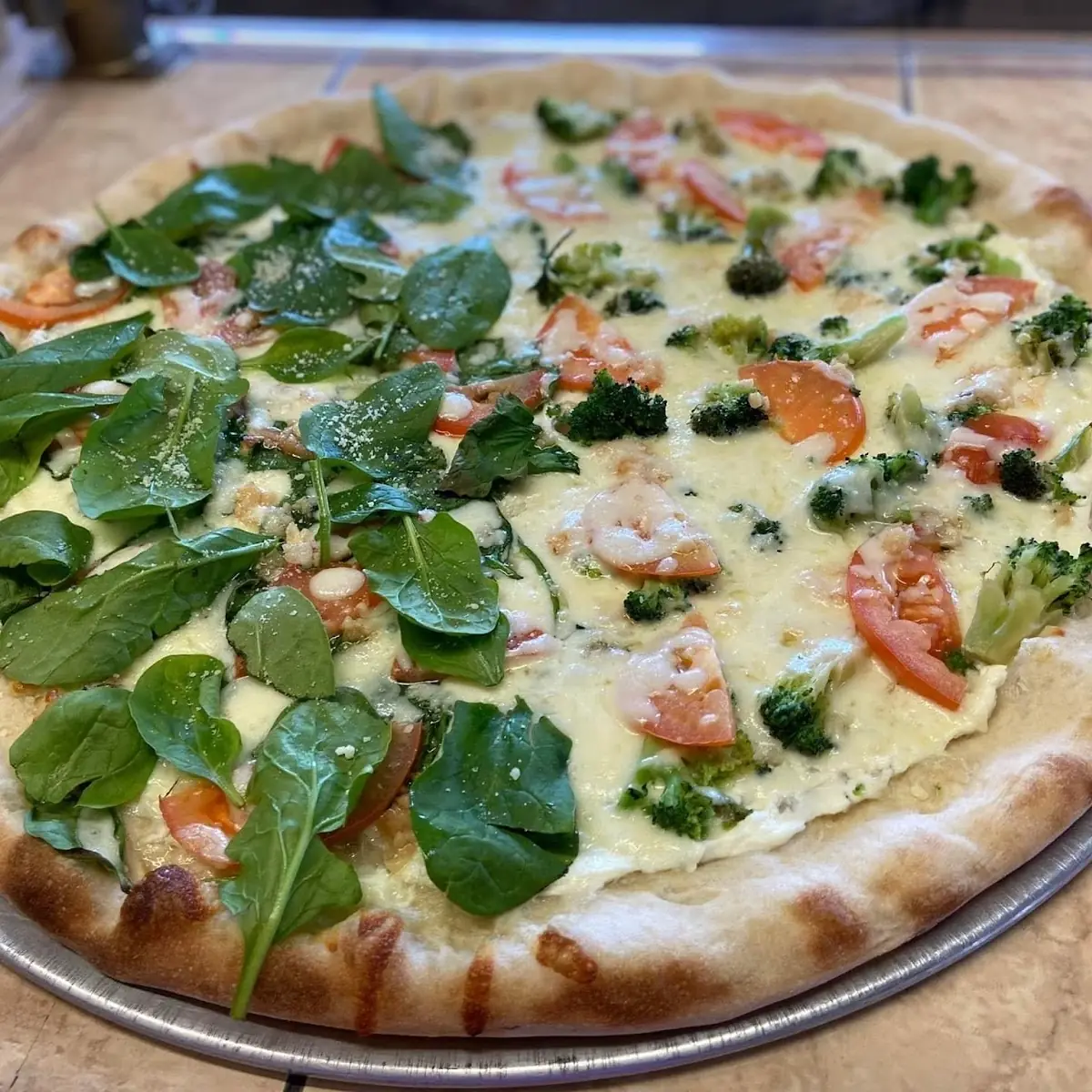 Gourmet White Pizza with Broccoli Ricotta Cheese Mozzarella Cheese Oil Garlic & Tomatoes
