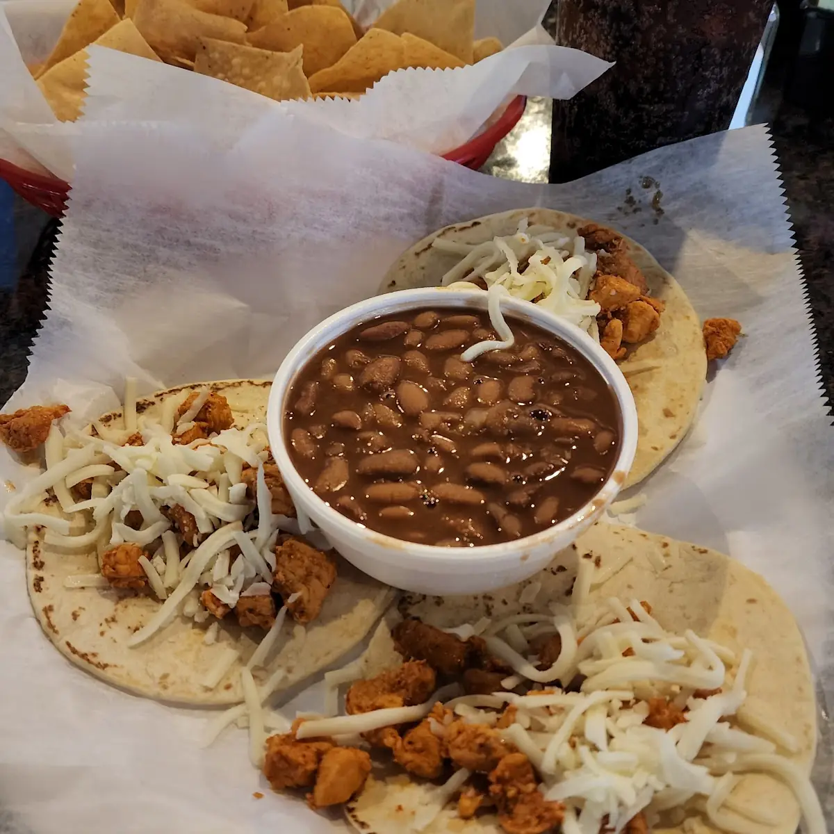 Three Chicken Tacos & Pinto Beans