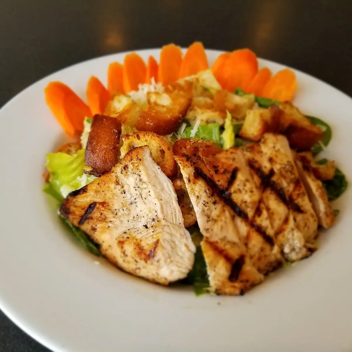 A Chicken Caesar Salad with Carrots