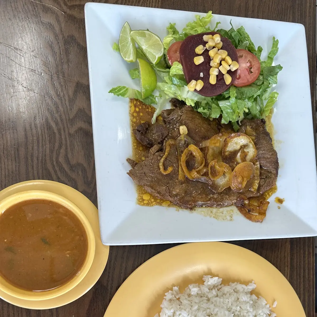Rice Beans and Bistec Encebollado Ensalada Mixta