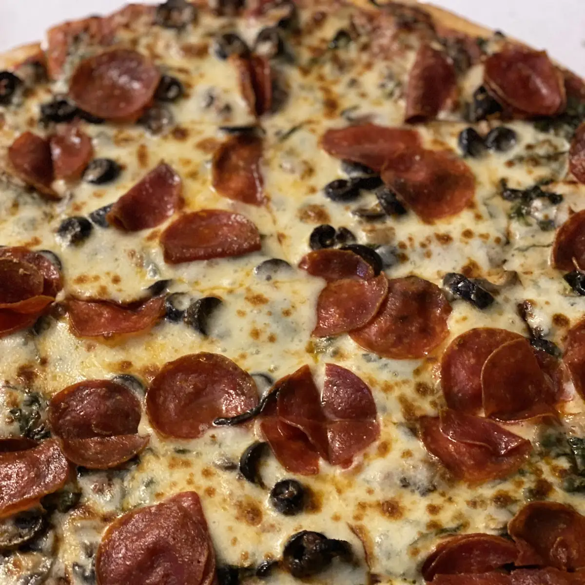Thin Crust Pepperoni Pizza with Spinach Mushrooms and Olives