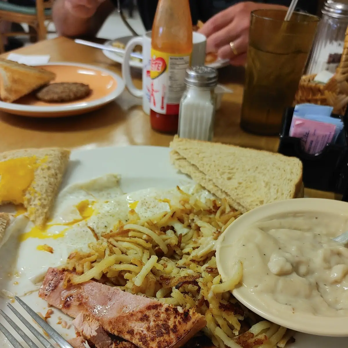 Ham Eggs Hash Browns and a Side of Sausage Gravy