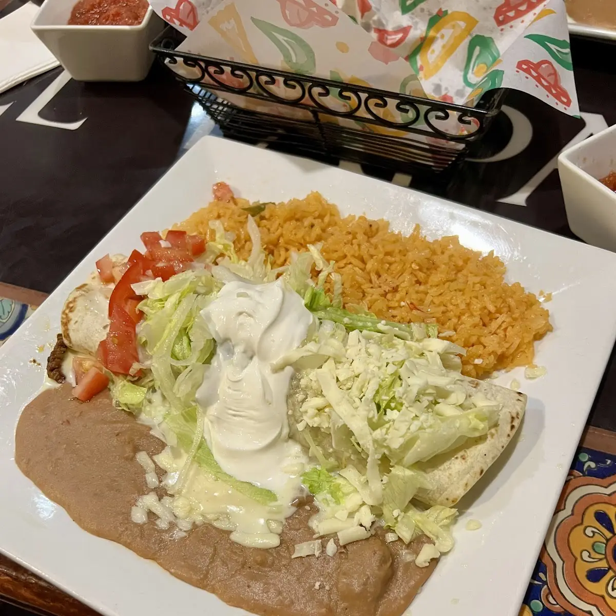 1 Bean Burrito, 1 Cheese Enchilada On a Bean Tostada Covered with Cheese Sauce