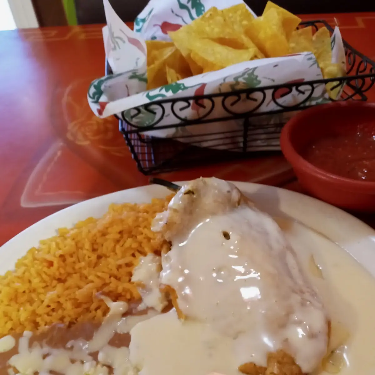 Chili Relleno with White Queso Rice and Refried Beans