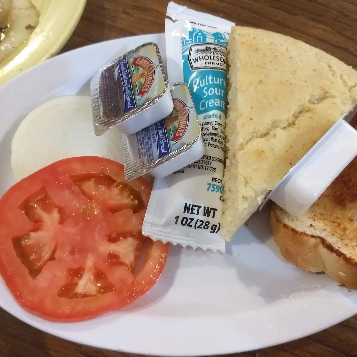 Condiments Tomato Slice Onion Slice Cornbread Barbeque Bread Butter and Sour Cream