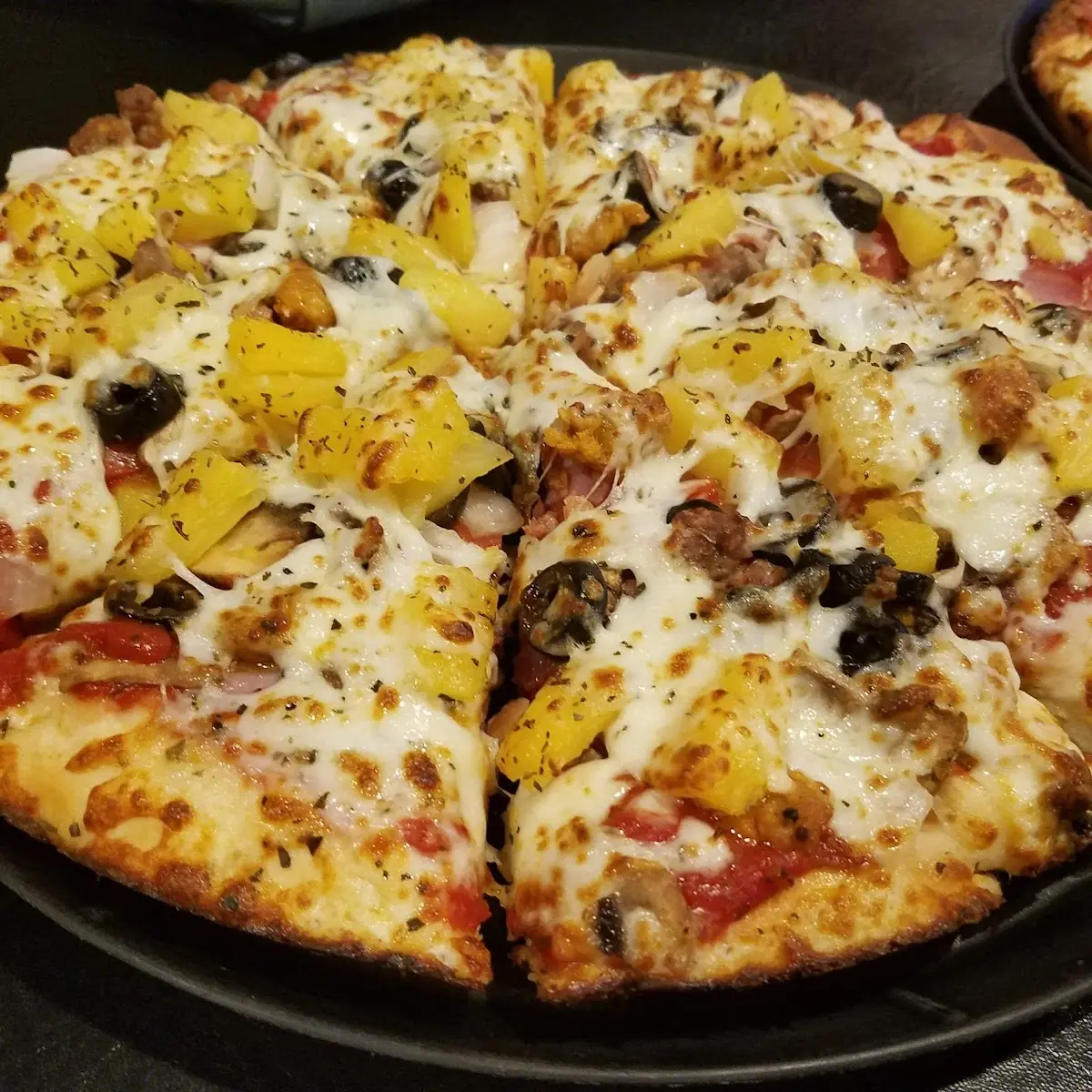 Deep Dish Pizza with Sausage Pepperoni Olives and Pineapple