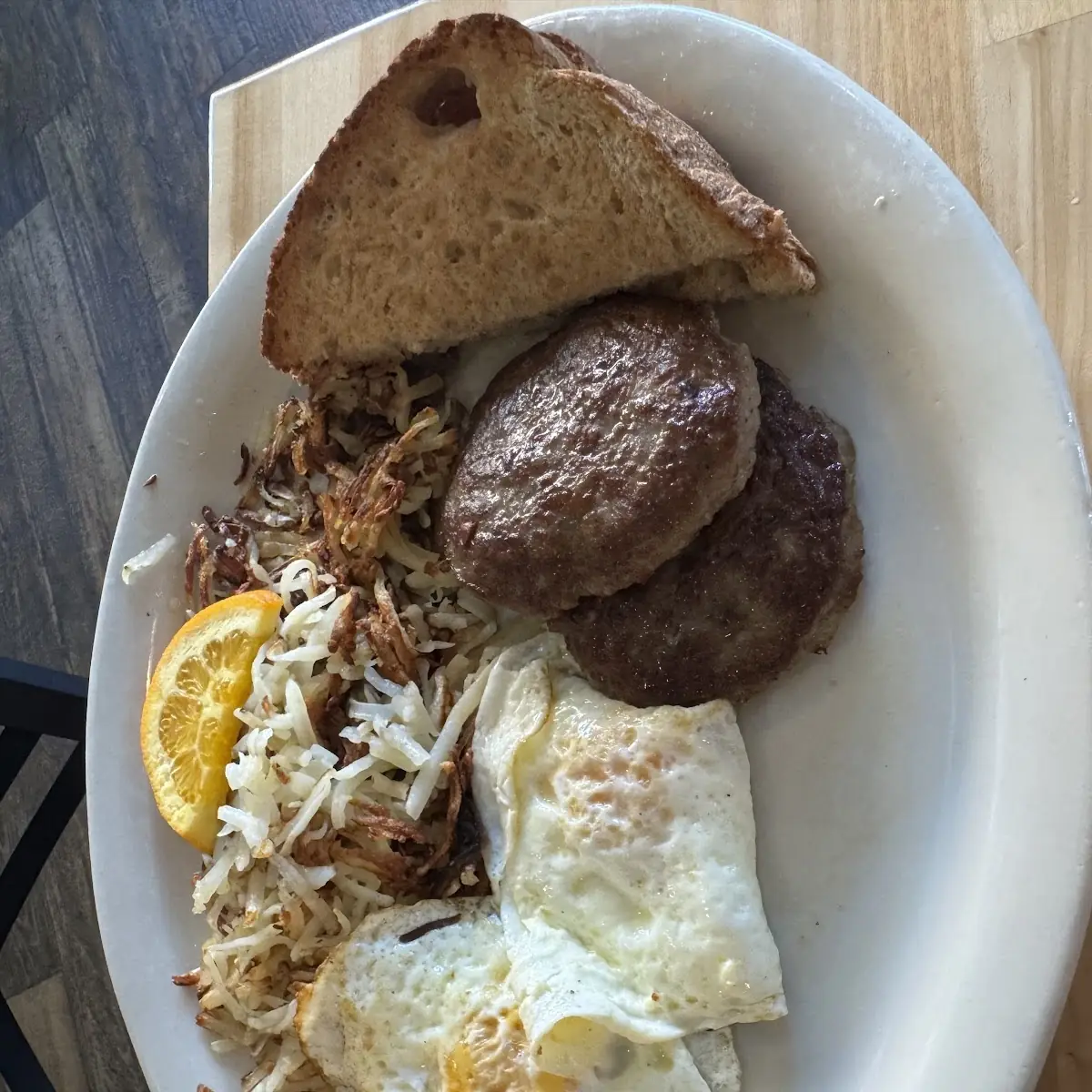 Basic Breakfast Eggs over Medium Sausage Patty Hand Pattied Hashbrowns Toast