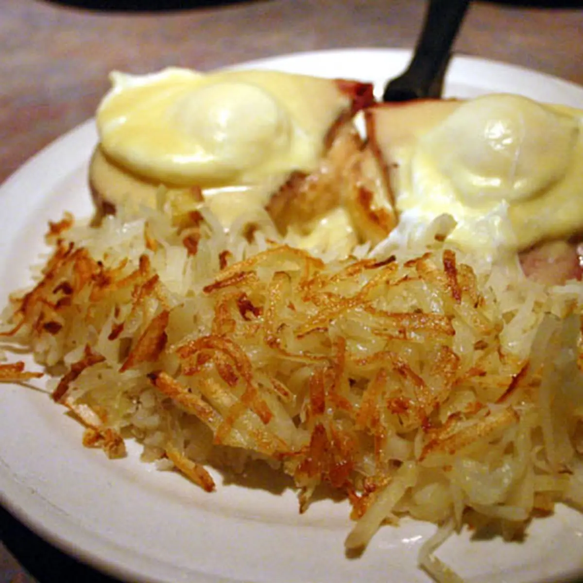 Eggs Benedict with a Side of Hash Brown Potatoes
